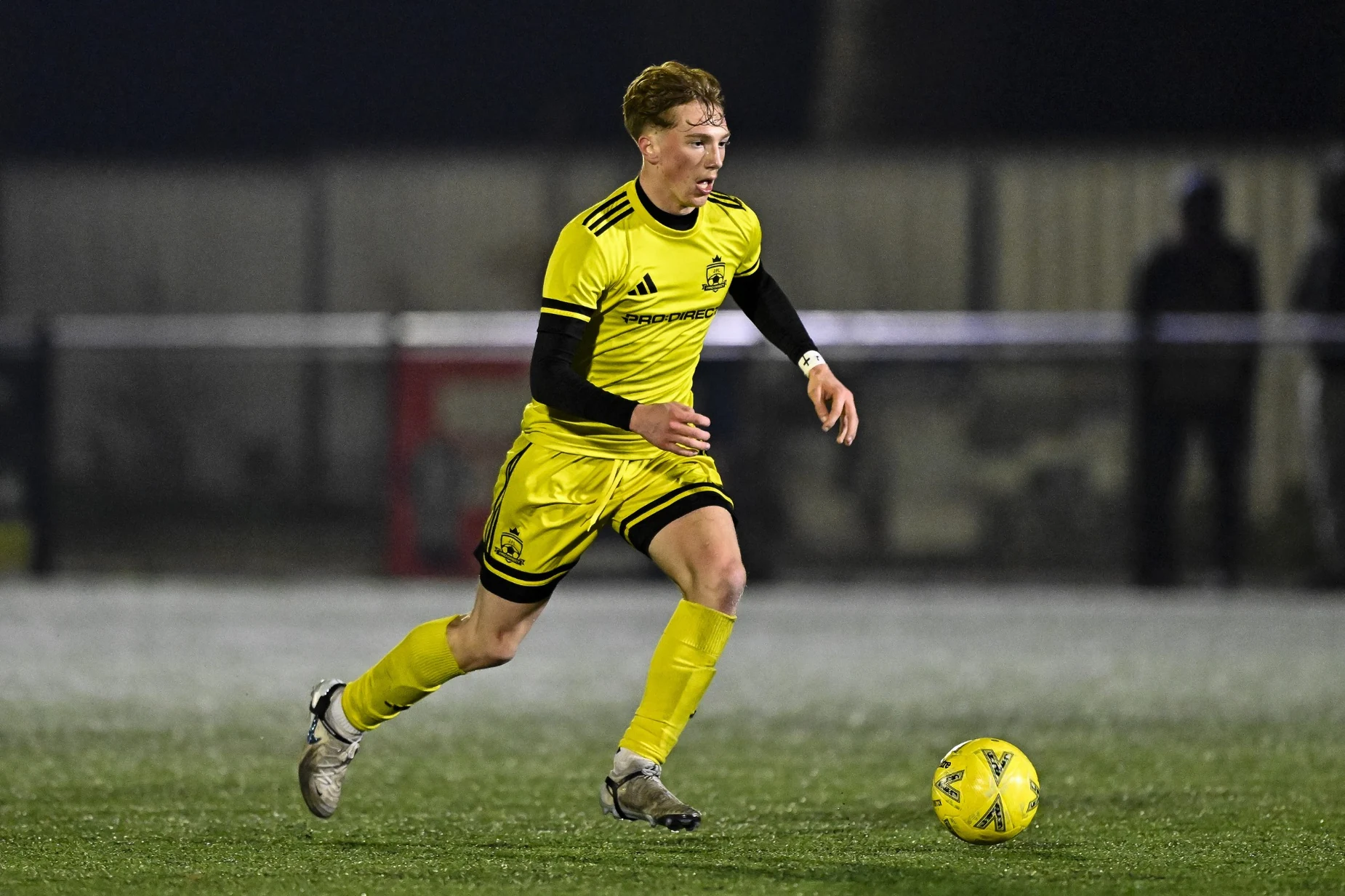 Louie Viccars playing in yellow football kit